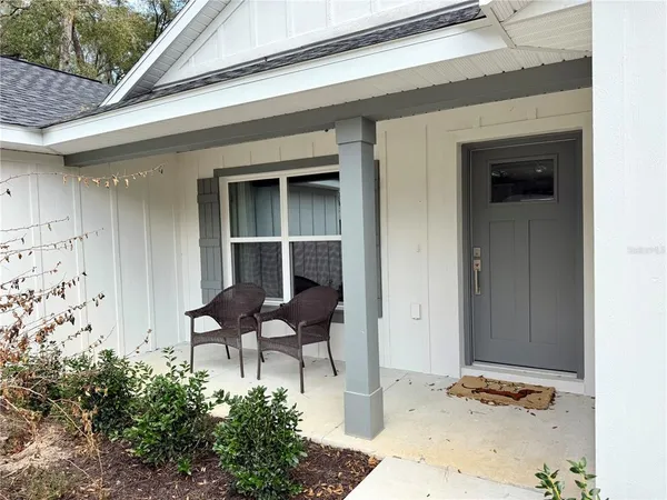 a backyard of a house with table and chairs