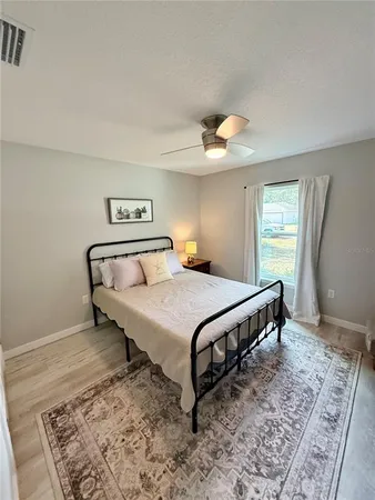 a bedroom with a bed and a dresser with rug