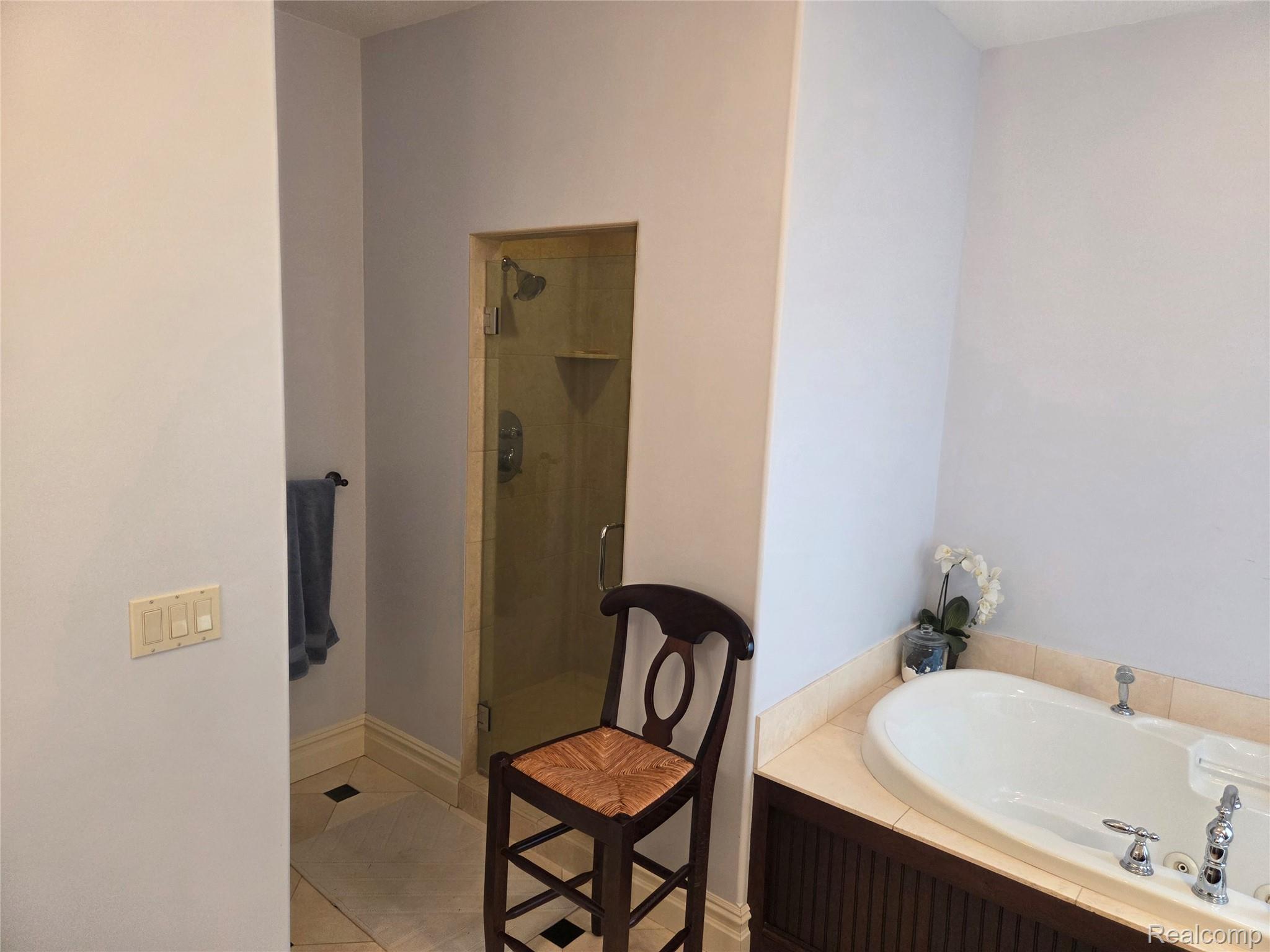 900 South Maxfield Road Brighton, MI 48114 - Photo 23 of 30 Full bathroom featuring a stall shower, a bath, and light tile patterned floors