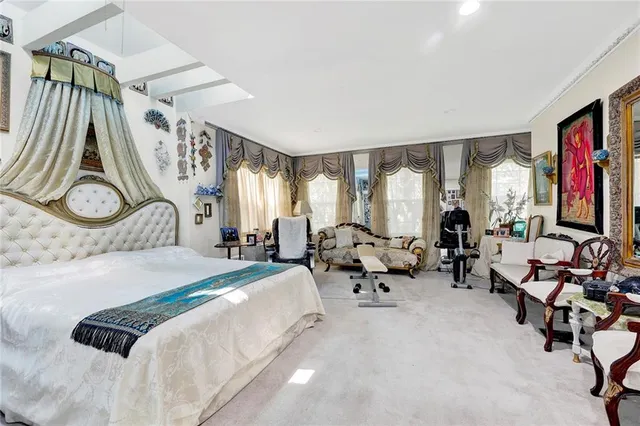 a bedroom with bed and glass windows