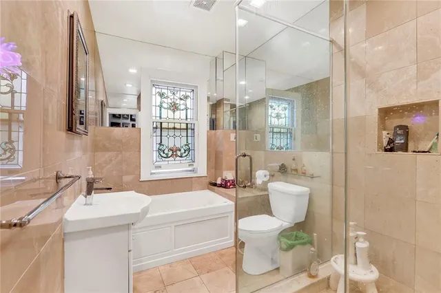 a bathroom with a sink toilet tub and shower