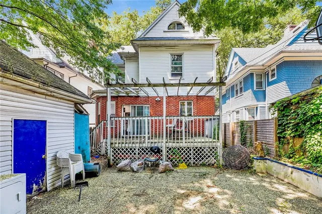 a view of a house with a fence and a porch