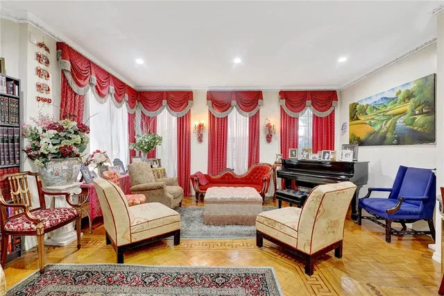 a living room with furniture and painting on the wall