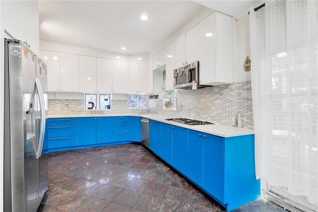 511 Argyle Road Brooklyn, NY 11218 - Photo 8 of 19 a kitchen with stainless steel appliances granite countertop a sink stove and refrigerator