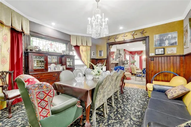 a living room with furniture chandelier and a large window