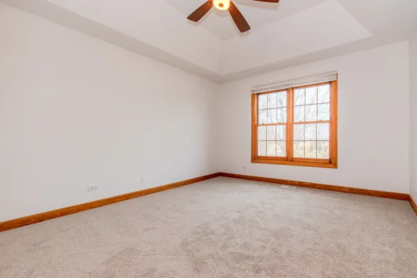 an empty room with a garage and a large window