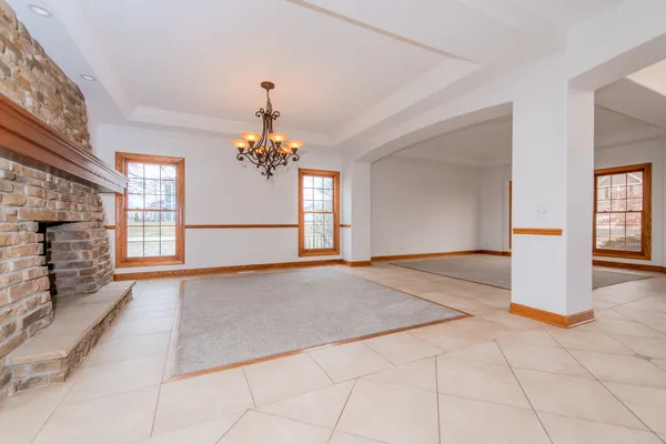 a view of a room with a fireplace and chandelier