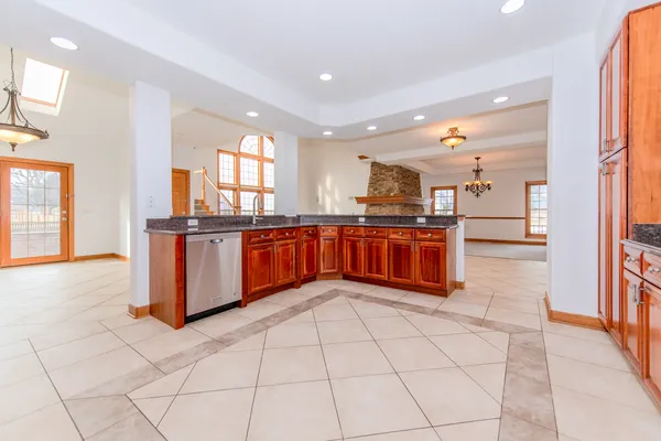 a kitchen with stainless steel appliances a sink and a large window