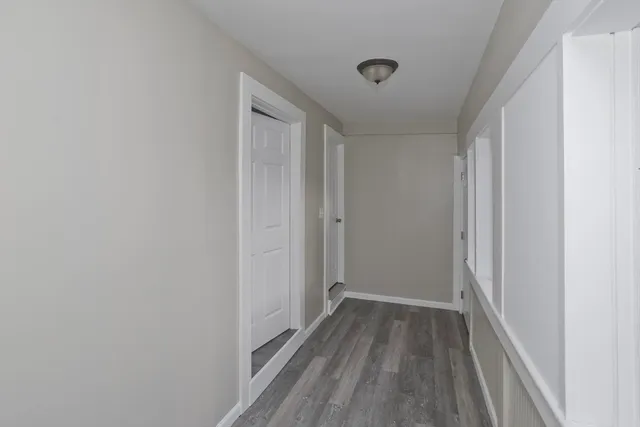a view of a hallway with wooden floor