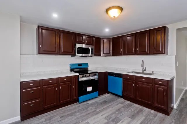 a kitchen with sink cabinets and stainless steel appliances