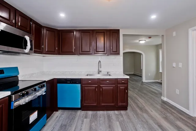 a kitchen with wooden cabinets and a sink