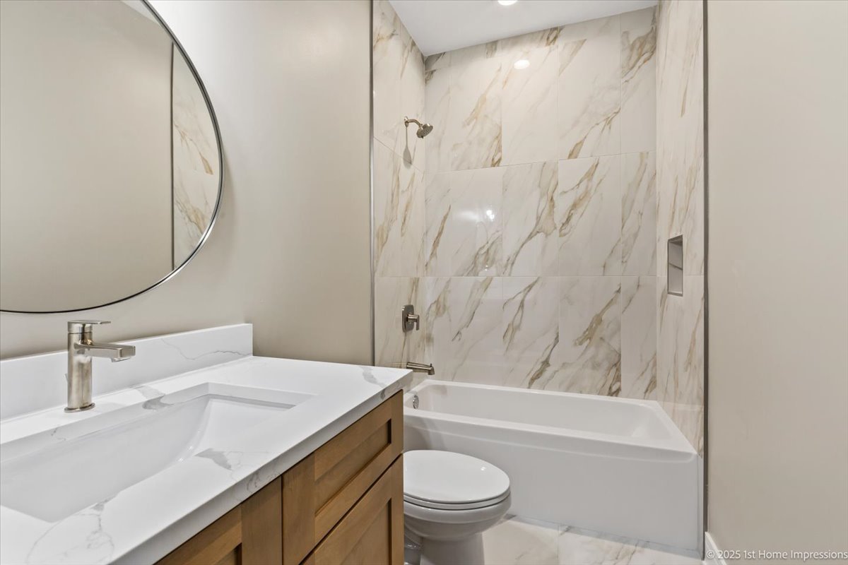 4932 South Champlain Avenue Chicago, IL 60615 - Photo 13 of 27 a bathroom with a sink a toilet and a mirror