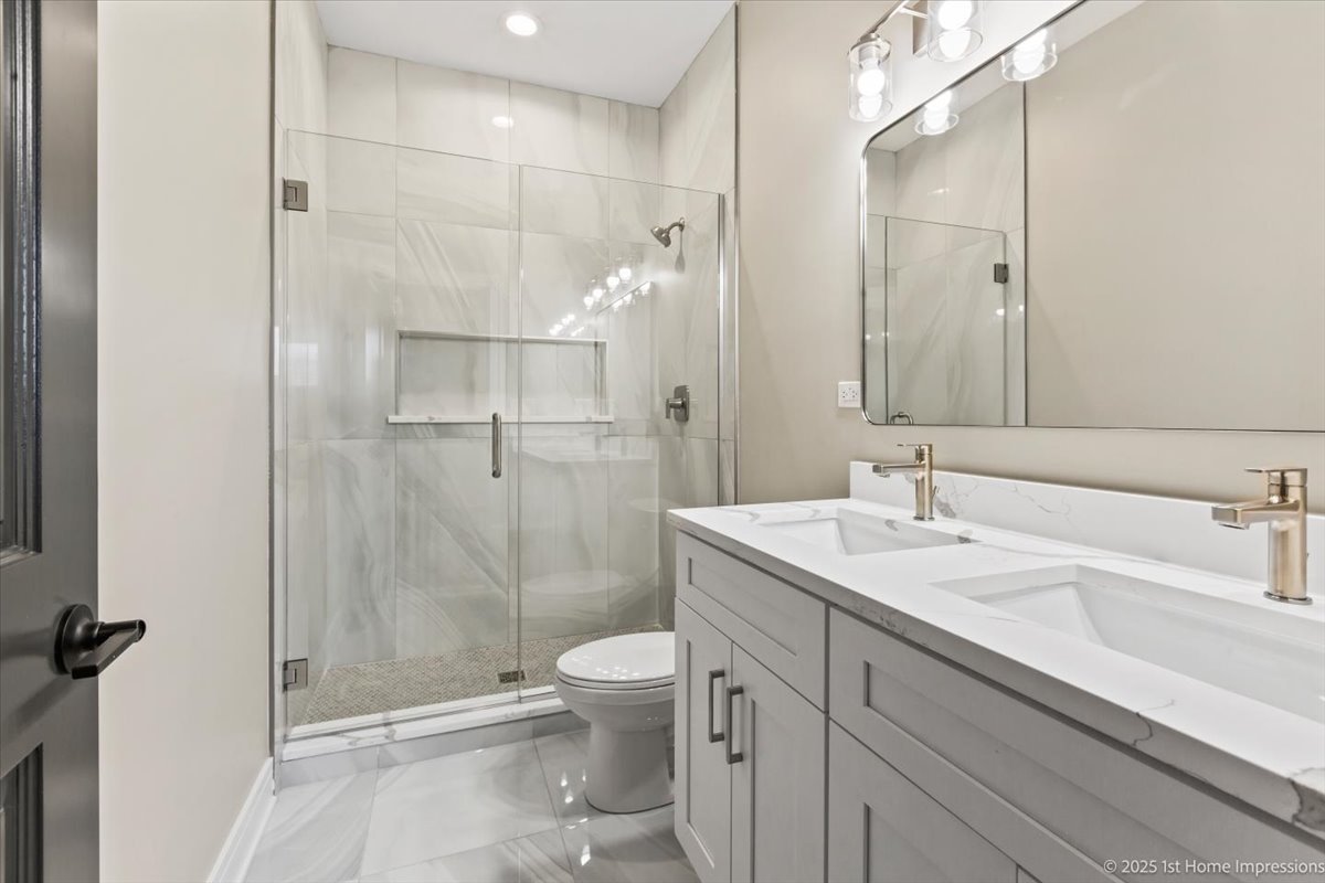 4932 South Champlain Avenue Chicago, IL 60615 - Photo 19 of 27 a bathroom with a sink a toilet and shower