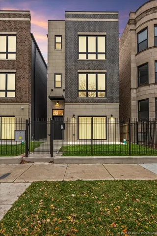 a front view of a brick house with a yard