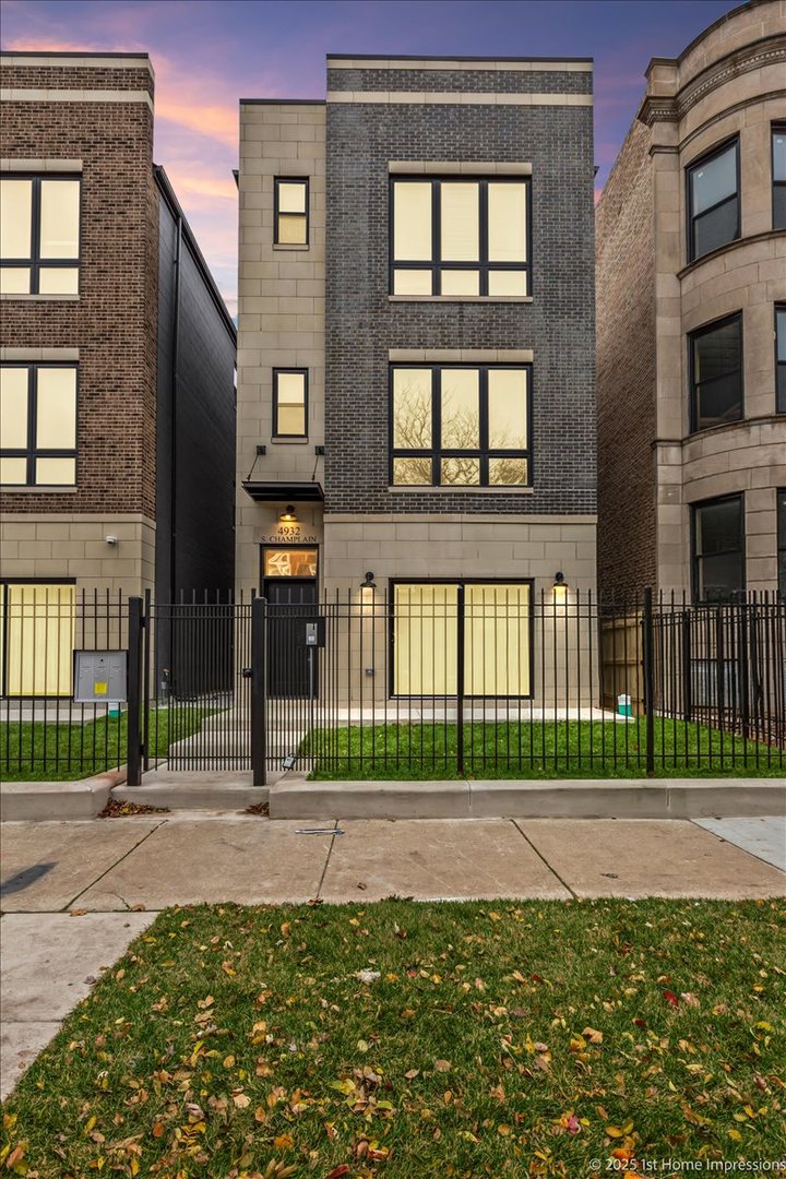 4932 South Champlain Avenue Chicago, IL 60615 - Photo 2 of 27 a front view of a brick house with a yard