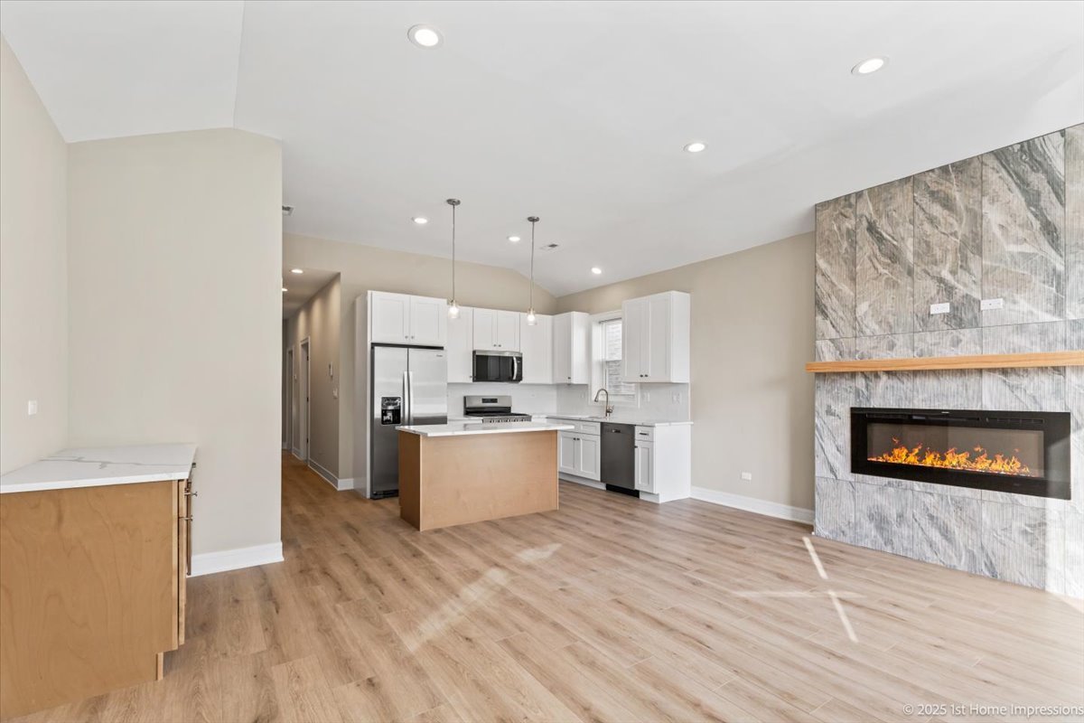 4932 South Champlain Avenue Chicago, IL 60615 - Photo 5 of 27 a large kitchen with stainless steel appliances a large counter top and a stove top oven