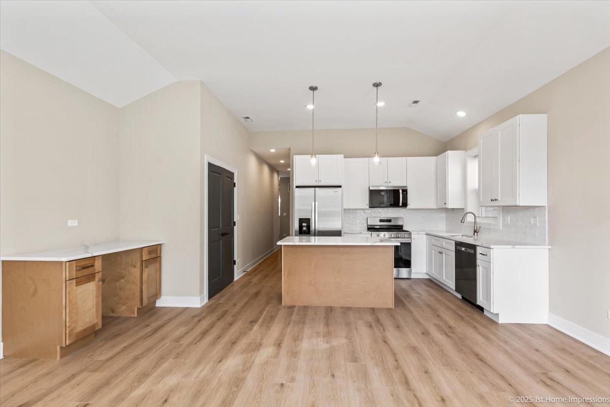 4932 South Champlain Avenue Chicago, IL 60615 - Photo 6 of 27 a kitchen with stainless steel appliances a refrigerator sink and microwave