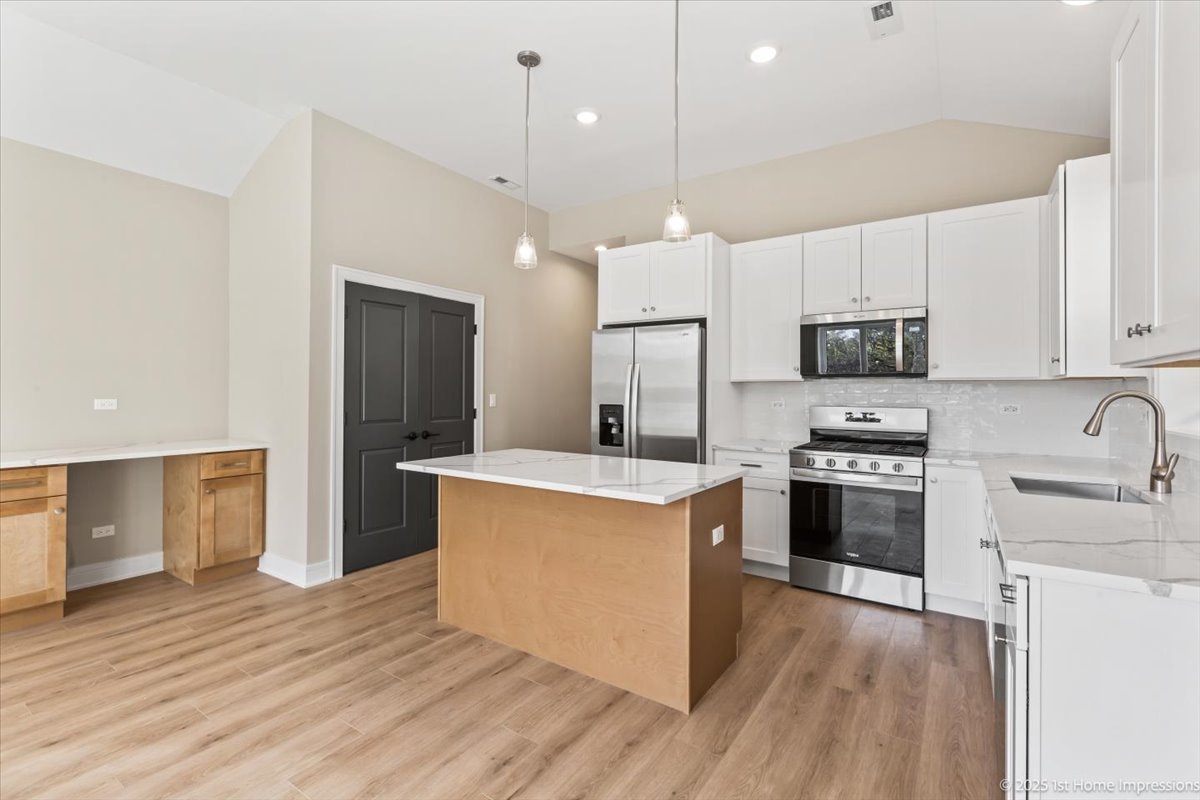4932 South Champlain Avenue Chicago, IL 60615 - Photo 7 of 27 a kitchen with stainless steel appliances granite countertop a stove a sink dishwasher a refrigerator and a oven with wooden floor