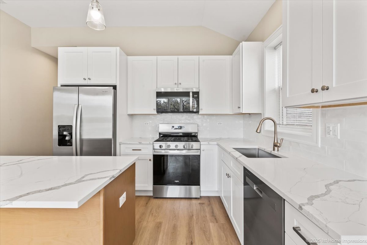 4932 South Champlain Avenue Chicago, IL 60615 - Photo 8 of 27 a kitchen with a sink a stove and refrigerator