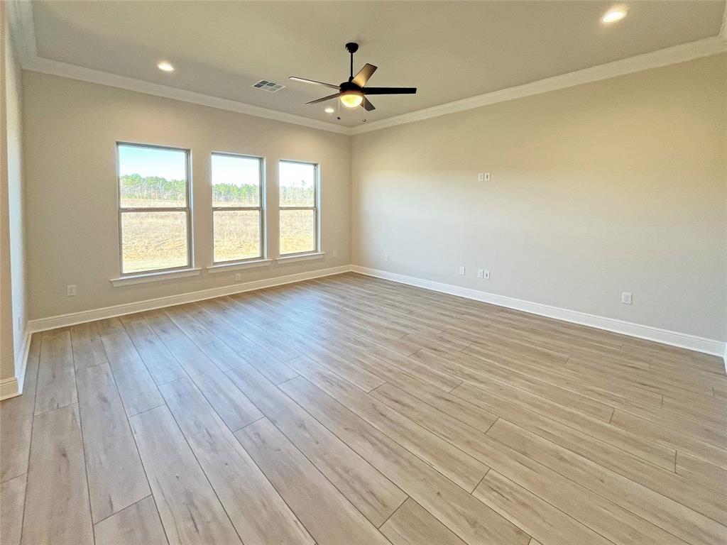 365 Hummingbird Lane Princeton, LA 71067 - Photo 11 of 22 an empty room with wooden floor fan and windows