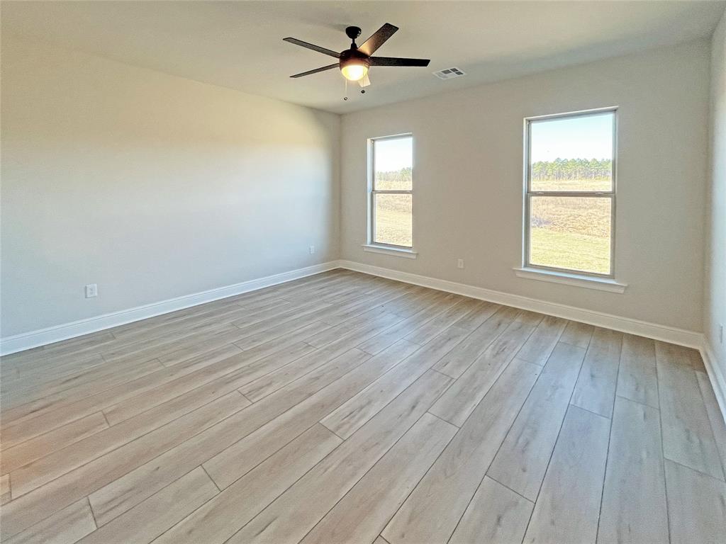 365 Hummingbird Lane Princeton, LA 71067 - Photo 13 of 22 wooden floor in an empty room with a window