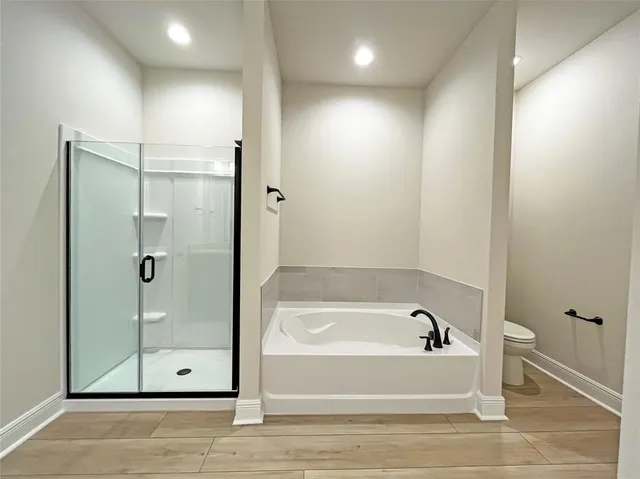 a bathroom with a bathtub and a shower