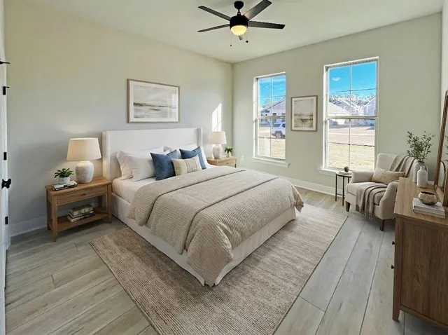 a bedroom with a bed and wooden floor