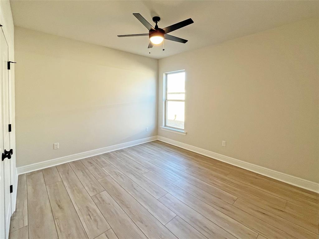 365 Hummingbird Lane Princeton, LA 71067 - Photo 6 of 22 an empty room with wooden floor and windows