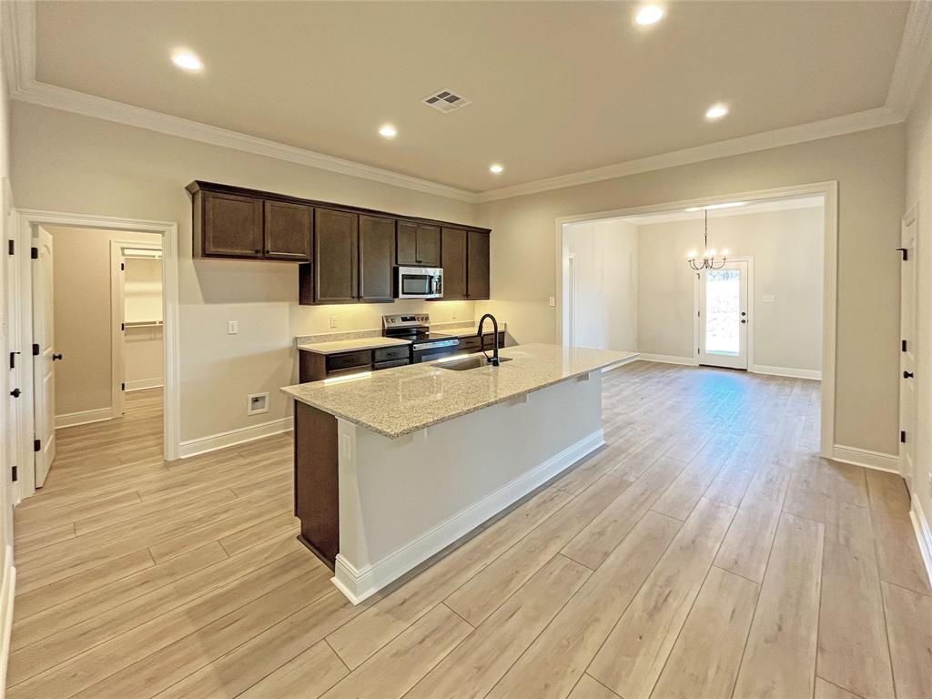 365 Hummingbird Lane Princeton, LA 71067 - Photo 7 of 22 a view of kitchen with cabinets appliances and wooden floor