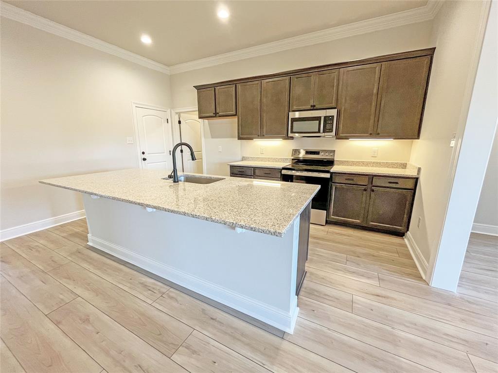 365 Hummingbird Lane Princeton, LA 71067 - Photo 9 of 22 a kitchen with stainless steel appliances granite countertop a stove a sink dishwasher and a refrigerator