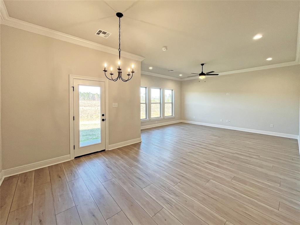 365 Hummingbird Lane Princeton, LA 71067 - Photo 10 of 22 a view of an empty room with wooden floor and a window