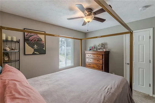 a bedroom with a large bed and a chandelier