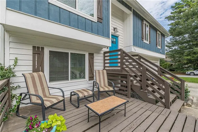 a view of a wooden chairs on the deck