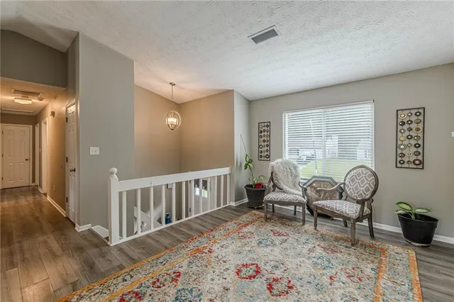 a bedroom with furniture and a wooden floor