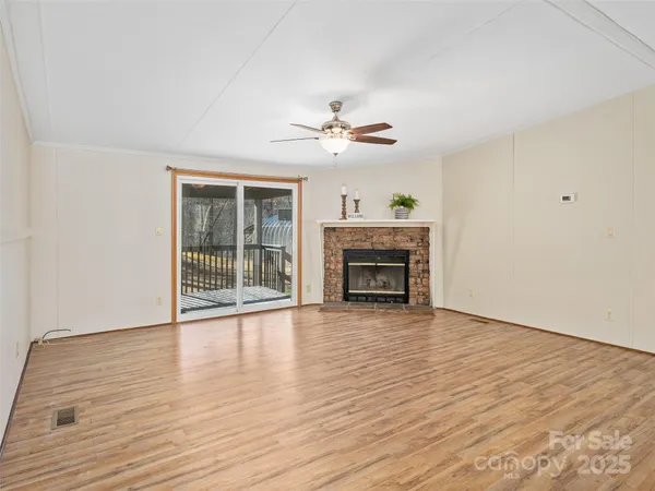 wooden floor fireplace and natural light in room
