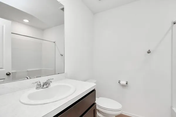 a bathroom with a sink toilet and a mirror