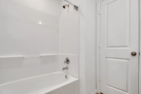 a bathroom with a granite countertop sink a toilet and a large mirror