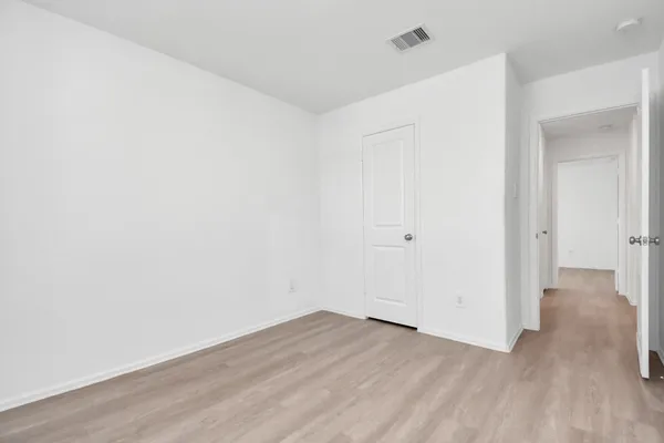 a view of a kitchen with wooden floor and a sink