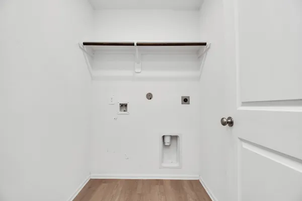 a view of a room with wooden floor