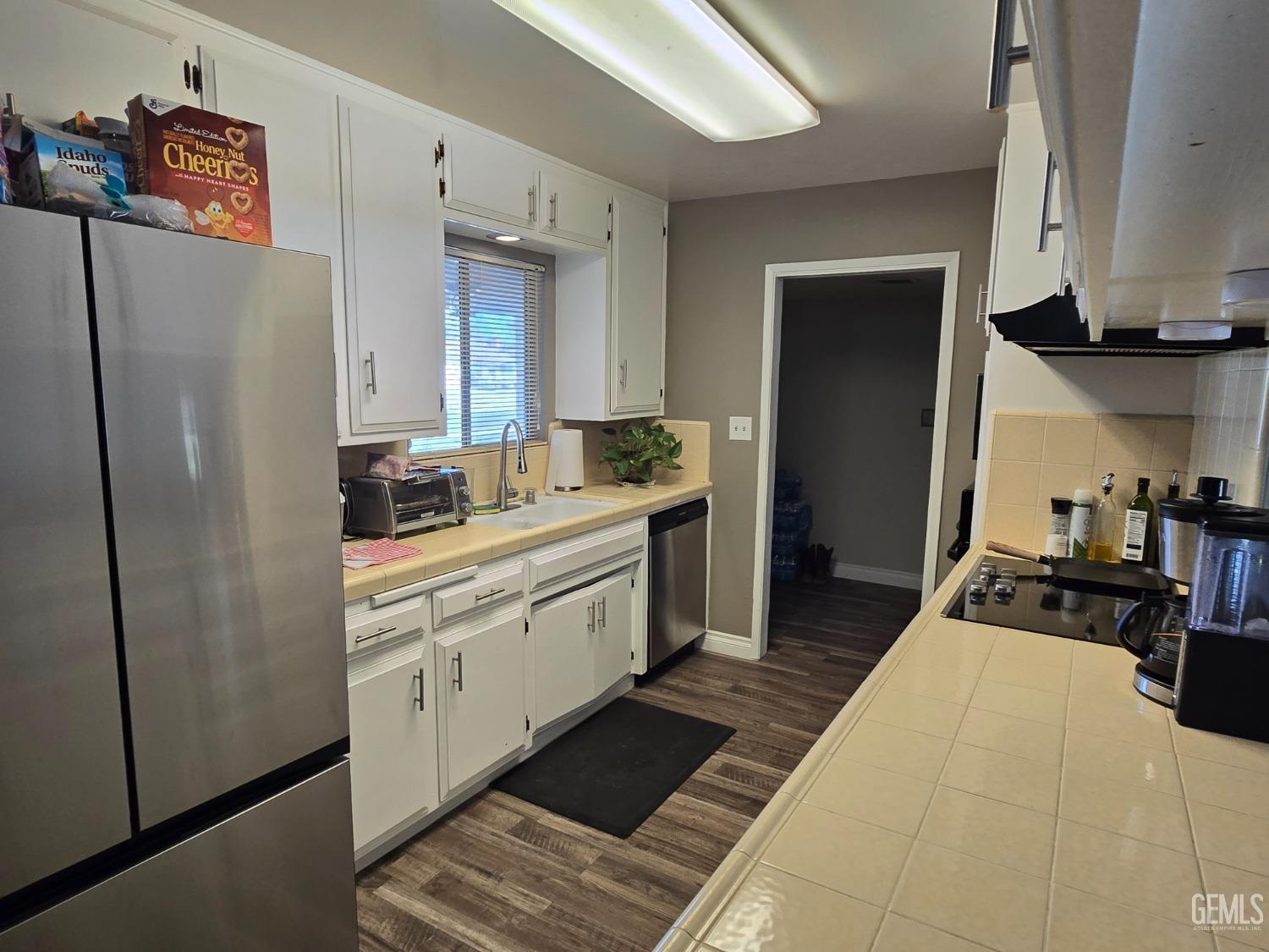Undisclosed Address Bakersfield, CA 93309 - Photo 4 of 14 a kitchen with stainless steel appliances a refrigerator sink and stove
