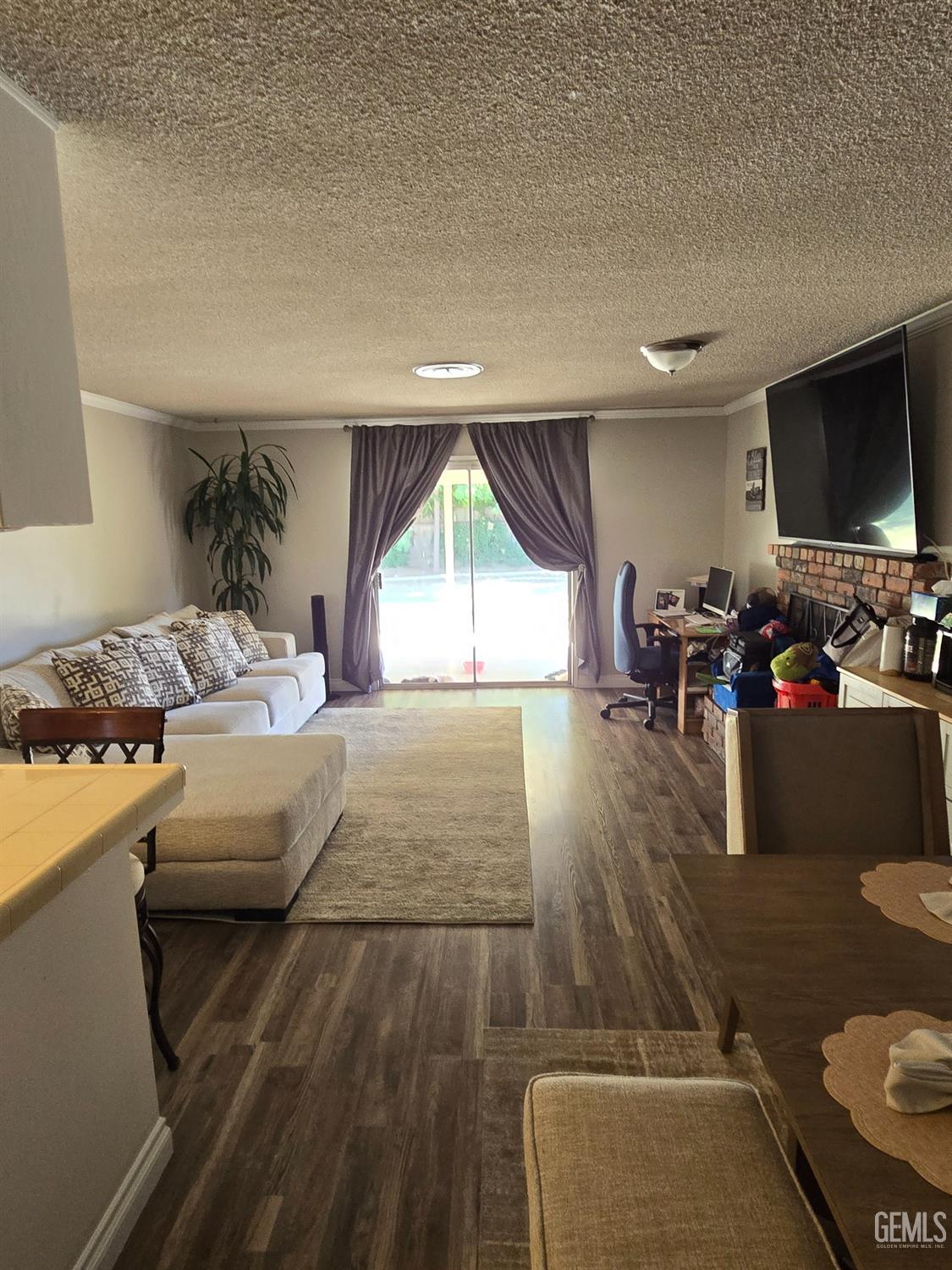 Undisclosed Address Bakersfield, CA 93309 - Photo 6 of 14 a bedroom with a bed and a flat tv screen on the dresser