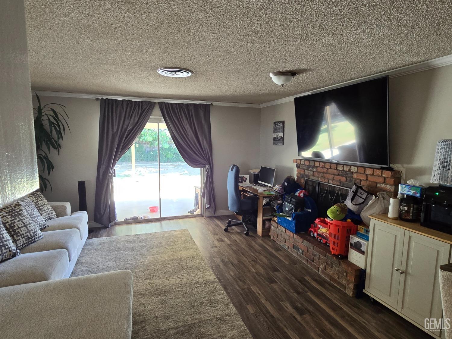 Undisclosed Address Bakersfield, CA 93309 - Photo 7 of 14 a living room with furniture fireplace and a flat screen tv