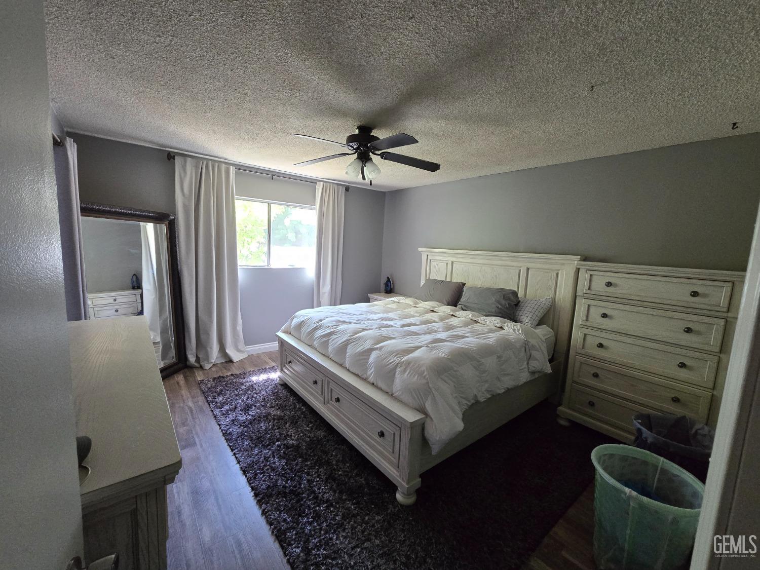 Undisclosed Address Bakersfield, CA 93309 - Photo 10 of 14 a bedroom with a bed and a dresser