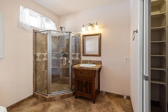 a bathroom with a shower and a sink