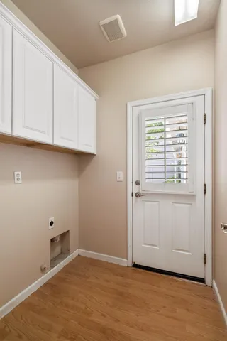 a view of an empty room with wooden floor