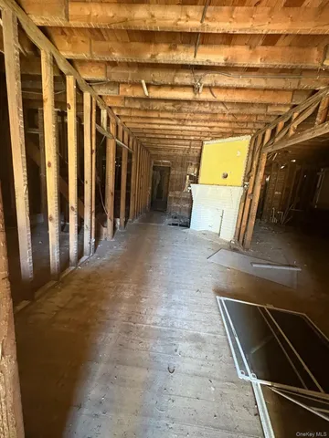 a view of a garage with wooden floor and stairs