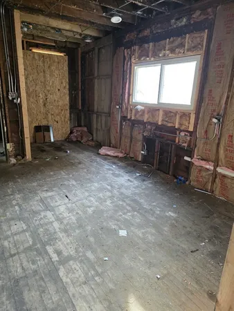 a view of an empty room with a fireplace