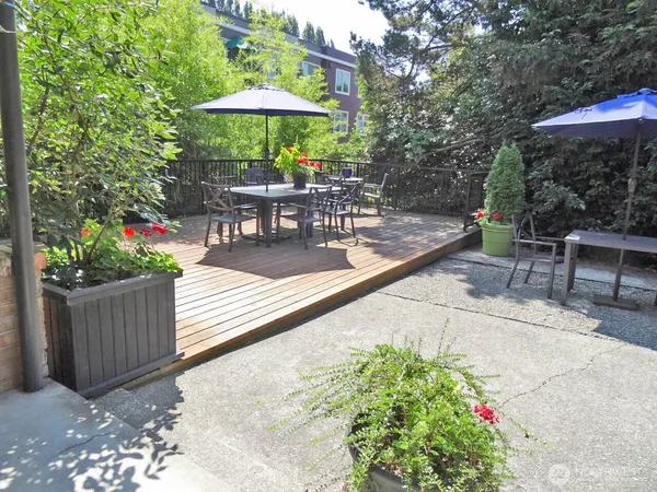 a view of a patio with a table and chairs under an umbrella