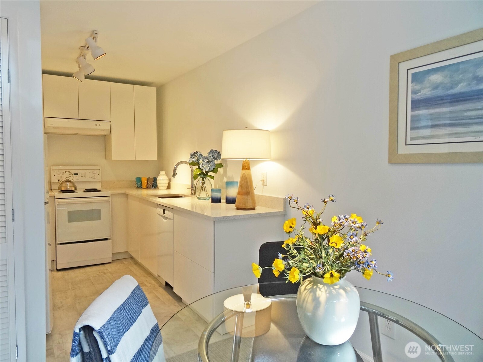 343 4th Avenue, Unit D Kirkland, WA 98033 - Photo 7 of 18 a white kitchen with a sink cabinets and wooden floor