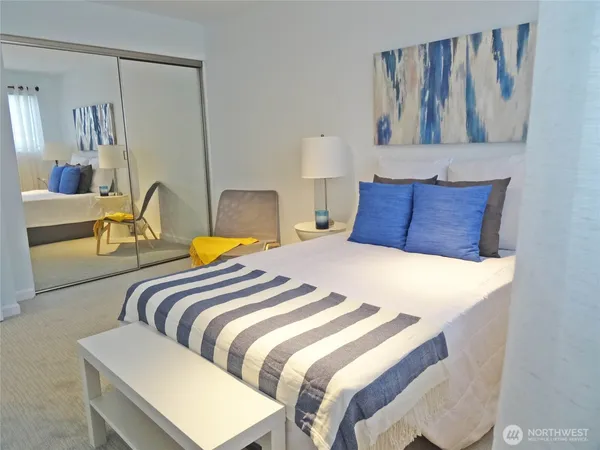 a bedroom with a bed and wall painting